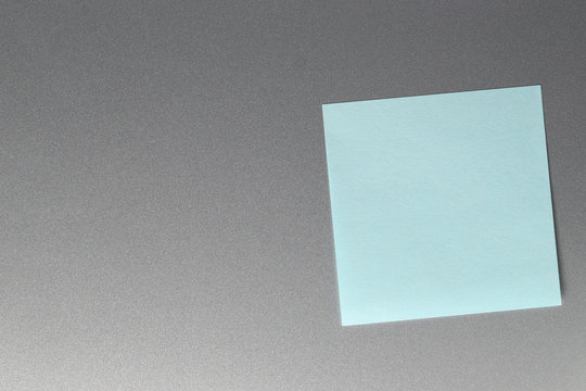 Empty blue paper sheet on refrigerator door.