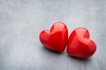 Red heart on the gray metal background.