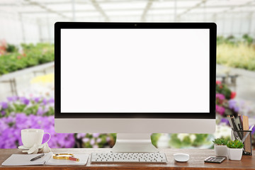Computer with blank screen on flower shop background
