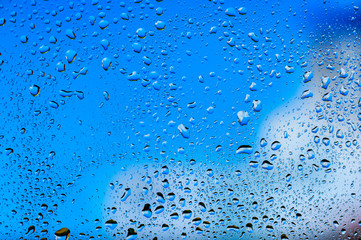 Abstract texture. Water drops on glass with blue background