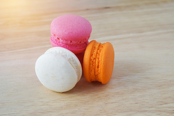 sweet macaroons on a  wooden background in soft focus
