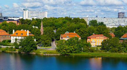 Fototapeta premium Landscape near the river. Spring, summer weather. Cloudy blue sky. Green trees.