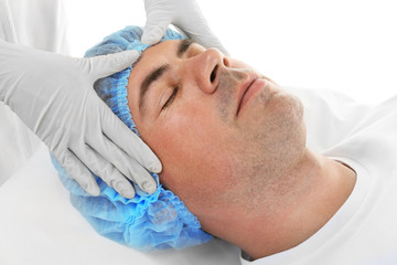 Fototapeta na wymiar Plastic surgery concept. Specialist checking male face