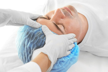 Obraz na płótnie Canvas Plastic surgery concept. Specialist checking male face