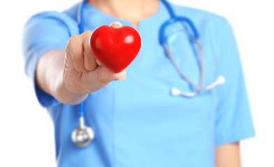 Doctor cardiologist with red heart and stethoscope on white background