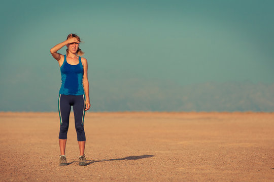 Young Woman In Wet Clothes Standing In The Desert