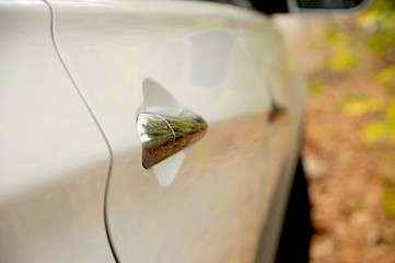 White korean car in details on autumn background