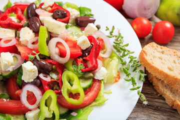 Greek salad on wooden background