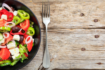 Greek salad on wooden background