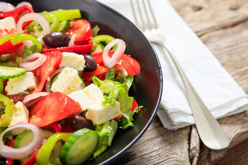 Greek salad on wooden background