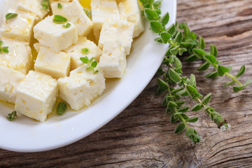 Feta cheece pieces on wooden background