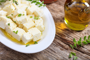Feta cheece pieces on wooden background