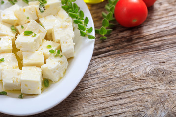 Feta cheece pieces on wooden background