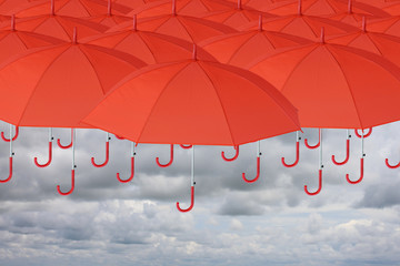 Many red umbrella on top and sky was going to rain.