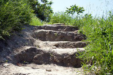 Earthmoving stage in the grass on the hillside.
