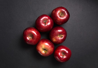red apple on black background.