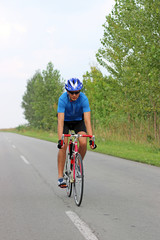 Fototapeta premium male cyclist riding a bike on an road