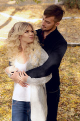 fashion outdoor photo of beautiful tender couple, wearing cozy clothes, walking by autumn park 
