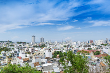 Obraz premium Bird's-eye view to buildings of the city Nha Trang in Vietnam at hot sunny day with cloudy sky