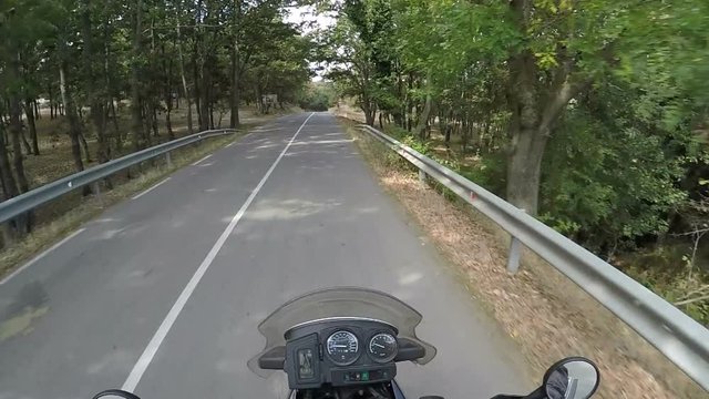 Riding Motorcycle by a Countryside Road