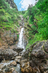 Fototapeta na wymiar gorgeous waterfall are hidden in the forest on a fine day and lush green trees , jokkradin waterfall in Thong pha phum national park at kanchanaburi province ,Thailand