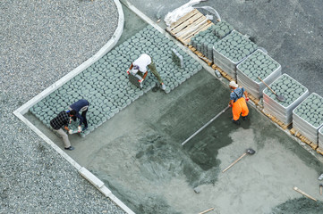 Workers constructing pavement