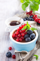 Delicious chocolate dessert with berries and mint served in ramekin.