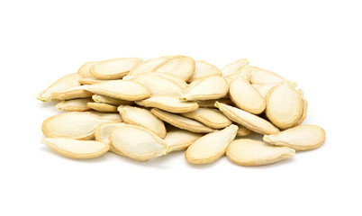 Group of dried pumpkin seeds on white