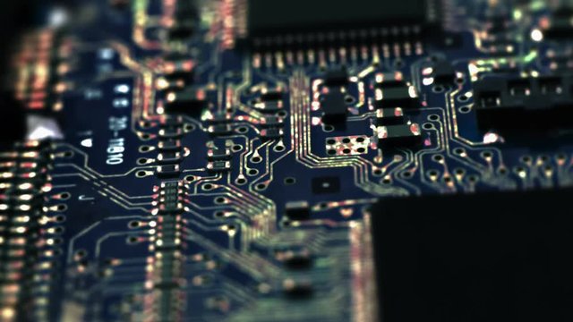 Circuit Board / Processor Chips / Data Streams. Macro tracking over circuit board with conceptual image of the red-green electrical signals flowing in electrical conductors.