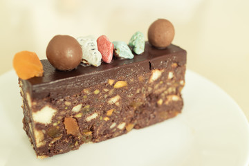 Tasty slice chocolate cake on top with chocolate ball and colorful sugar stone