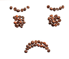 sad smiley made of coffee beans on white background