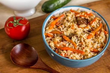 Photo of dish of uzbek pilaf made of rice and carrots, meat and onions