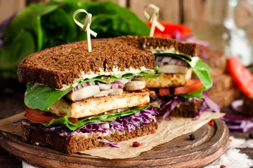 Fotobehang vegan sandwich with tofu and vegetables © yuliiaholovchenko
