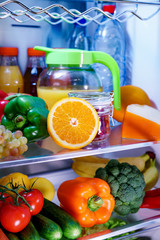 Fototapeta na wymiar Open refrigerator filled with food