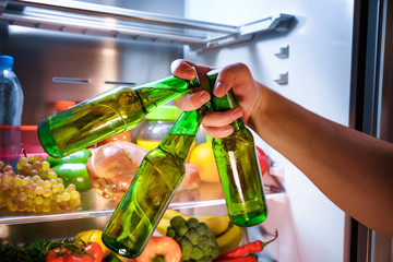 Man taking beer from a fridge