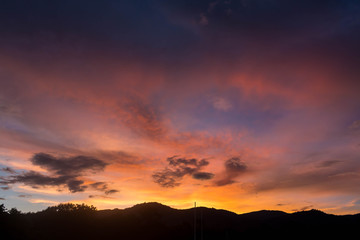 background sun filtered cloudscape morning sunrise over silhouetted mountains