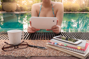 Woman using phone in swimming pool