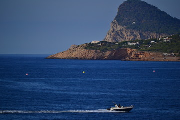 Fototapeta na wymiar Beautiful island with a boat passing