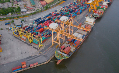 Fototapeta na wymiar Aerial view of cargo ships loading containers at seaport