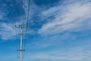 Obraz premium electrical post by the road against blue sky