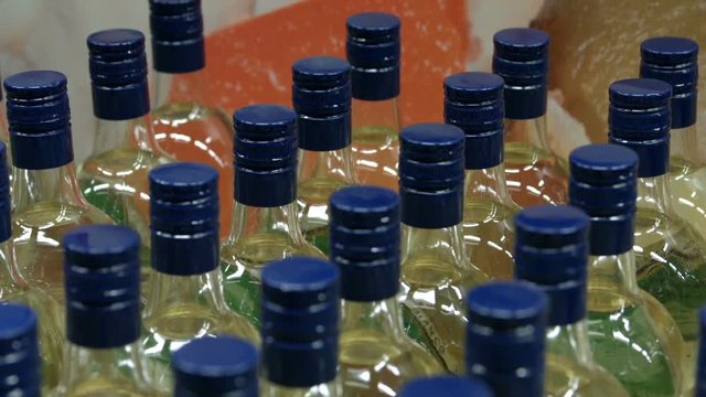 Bottles of alcoholic drink close-up. The goods are on a supermarket shelves
