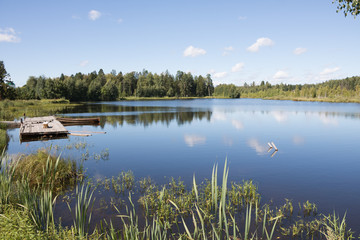 Landscape with a boat at the pier on the lake