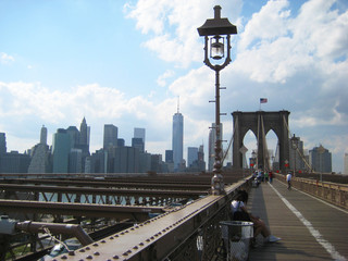 Brooklyn Bridge famous symbol of New York City, USA with downtown Manhattan skyscrapers landscape,...