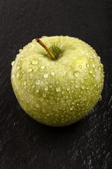 one wet apple on slate