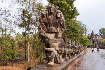 Fototapeta na wymiar Stone sculptures near South Gate of Angkor Thom from outside the city. Angkor Wat. Siem Reap, Cambodia. UNESCO World Heritage Site.
