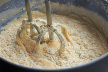 Electric mixer beats mass of batter