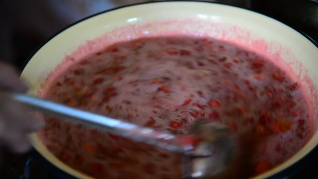Housewife takes foam with strawberry jam