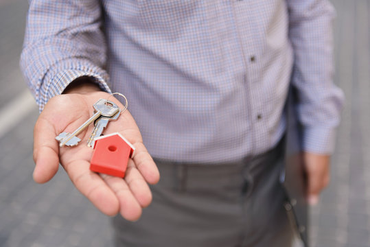 Smiling Man Holding Up Keys