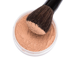 Makeup brush with jar of loose cosmetic powder isolated on white