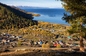 Village on coast of lake in mountains